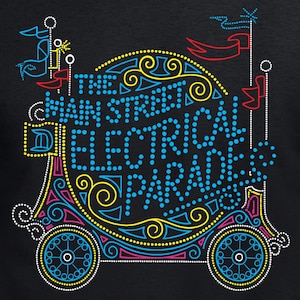 May include: Black t-shirt featuring a colorful graphic of a parade float with the text "The Main Street Electrical Parade." The design includes blue, yellow, pink, and white neon-style lights, with decorative swirls and flags.