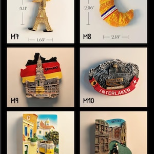 May include: Collection of travel-themed souvenir magnets. Includes a gold Eiffel Tower (3.11" tall), a croissant (2.36" tall), a Germany-themed magnet, a Swiss Alps magnet, a Lisbon tram magnet, and a Venice canal magnet.