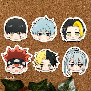 May include: Six cartoon character stickers with different hairstyles and facial expressions. The stickers are on a corkboard background. The characters have black, red, yellow, and blue hair. The stickers are all in a chibi style.