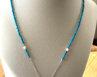Handmade dolphin pendant necklace with blue beads.