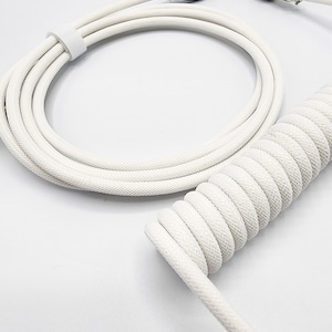 May include: White coiled cable with a USB connector on one end and a metal connector on the other end.