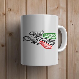 May include: White ceramic mug with a black and white stylized image of an eagle with green, red, and white accents. The eagle is a symbol of Mexico.