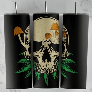 May include: Three black stainless steel tumblers with a skull and mushroom design. The skull is white with orange mushrooms growing out of the top. Green leaves surround the skull.