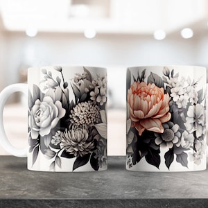 May include: Two white ceramic mugs with floral designs. One mug features a bouquet of black and white flowers, while the other mug features a bouquet of black, white, and orange flowers.