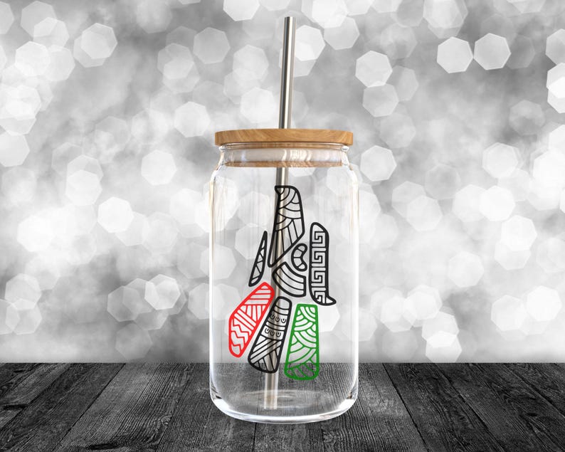 May include: A clear glass jar with a wooden lid and a metal straw. The jar has a black and white design with red, green, and white accents. The design is a stylized tree with geometric shapes.