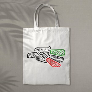 May include: White tote bag with a black and white outline of a stylized eagle with red and green accents. The eagle is a symbol of Mexico.