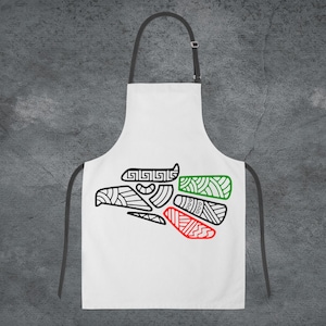May include: White apron with a black and green stylized eagle design. The eagle is outlined in black and filled with green, red, and white colors.