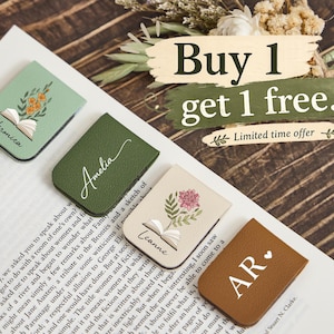 May include: Four rectangular magnetic bookmarks in sage green, forest green, cream, and brown. The sage bookmark features an open book with orange flowers and the name Veronica. The cream bookmark shows an open book with a pink flower and the name Leanne. The forest green bookmark has the name Amelia, and the brown bookmark displays the initials AR with a heart.