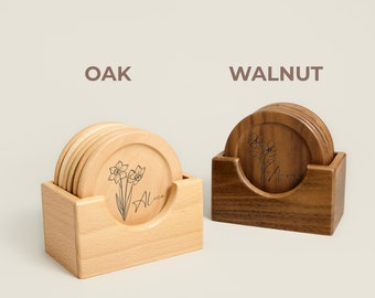 May include: Two sets of coasters, one in oak and one in walnut, each with a floral design and the name "Alice" engraved on the bottom. The coasters are stacked in a holder.