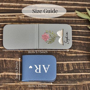May include: A gray magnetic bookmark featuring a floral book illustration and the name Sophia, measuring 3.15 inches by 1.2 inches, and a blue magnetic bookmark with the letters AR and a heart, measuring 1.57 inches by 1.2 inches.