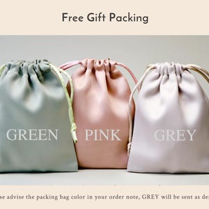 K&ouml;nnte beinhalten: Drei Kordelbeutel in Gr&uuml;n, Rosa und Grau. Die Beutel sind aus einem weichen, seidenartigen Material gefertigt und eignen sich perfekt zum Verpacken von Geschenken. Der Text "Free Gift Packing" befindet sich oben im Bild. Der Text "Bitte geben Sie die Farbe des Verpackungsbeutels in Ihrer Bestellnotiz an, GRAU wird standardm&auml;&szlig;ig versandt" befindet sich unten im Bild.