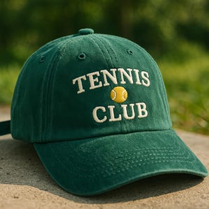 May include: A green baseball cap with the text "Tennis Club" embroidered in white with a yellow tennis ball graphic.