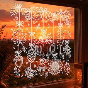 May include: A white line art window decal featuring hanging autumn elements including a central pumpkin, a sunflower, an acorn, a pinecone, a mushroom, and various leaves and berries, all suspended by thin lines with small decorative bows.