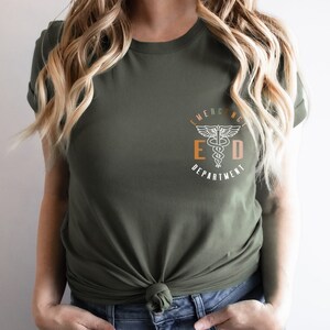 May include: A green t-shirt with a white graphic of a medical symbol and the text "Emergency Department" in a circle.