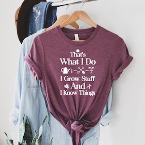 May include: A maroon t-shirt with white text that reads "That's What I Do I Grow Stuff And I Know Things". The text is accompanied by gardening-related icons.