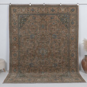 7.5 x 9.9 feet vintage persian rug, Warm brown background with muted blue floral and medallion details.
