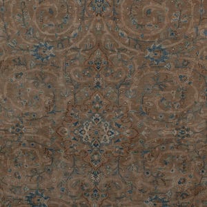 A Close-up of vintage persian rug, Warm brown background with muted blue floral and medallion details. 7.5 x 9.9 feet
