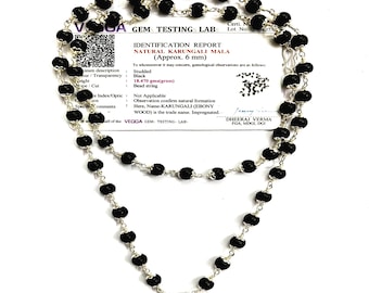 May include: A double-strand necklace featuring black, spherical beads strung on a silver chain. The necklace is accompanied by a white identification report from a gem testing lab, detailing the beads as natural Karungali, approximately 6 mm in size.