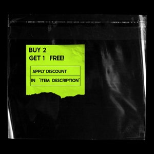 May include: A bright yellow torn paper note with black text that reads "BUY 2 GET 1 FREE! APPLY DISCOUNT IN "ITEM DESCRIPTION""