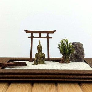 Miniature Zen garden with Buddha, torii, rake, moss and amethyst