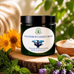 May include: A dark green jar of Magnesium Eazzze Cream with a black lid and a white label. The label features a tree logo, the text "MAGNESIUM EAZZZE CREAM", a silhouette of a person, and "Infused with Arnica and Comfrey, Net Wt. 5 oz".