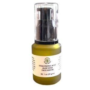 May include: A green glass bottle of face serum with a clear pump top. The label reads "Hyaluronic Acid Aloe Vera Face Serum" and weighs 1 oz (28 gms). The bottle has a matte finish and a black pump.