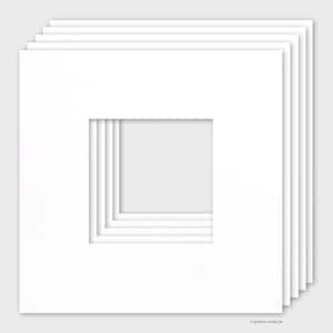 May include: A stack of white picture mats with square openings. The mats are layered, creating a dimensional effect. The image is well-lit, highlighting the clean lines and crisp edges of the mats. The mats are designed for framing artwork or photographs.
