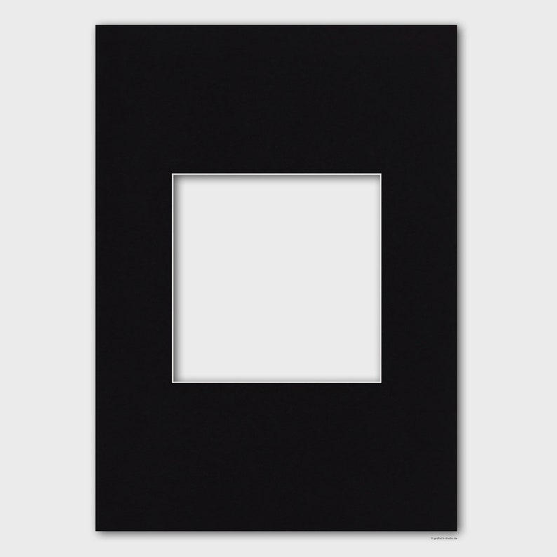 May include: Black mat board with a white window opening. The mat board is designed to be used for framing artwork or photographs.