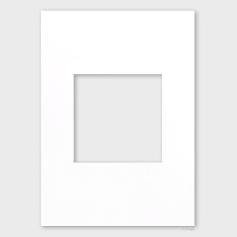 May include: A white mat with a rectangular opening in the center. The mat is designed to be used for framing artwork or photographs.