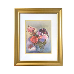 May include: A framed floral print featuring a bouquet of red, pink, and purple flowers in a blue vase. The artwork is set against a light background and framed in a gold-colored wooden frame with a white mat.