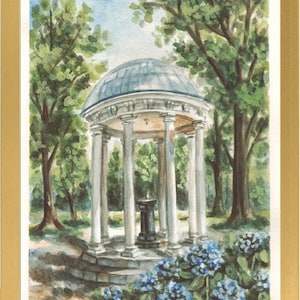May include: A watercolor painting in a gold frame depicting a white domed gazebo with columns in a park setting. The scene features lush green trees, a dark central pedestal, and clusters of blue hydrangea flowers in the foreground. The year 2026 is visible.