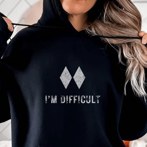 May include: Black hoodie with a white diamond graphic and the text "I'm Difficult".
