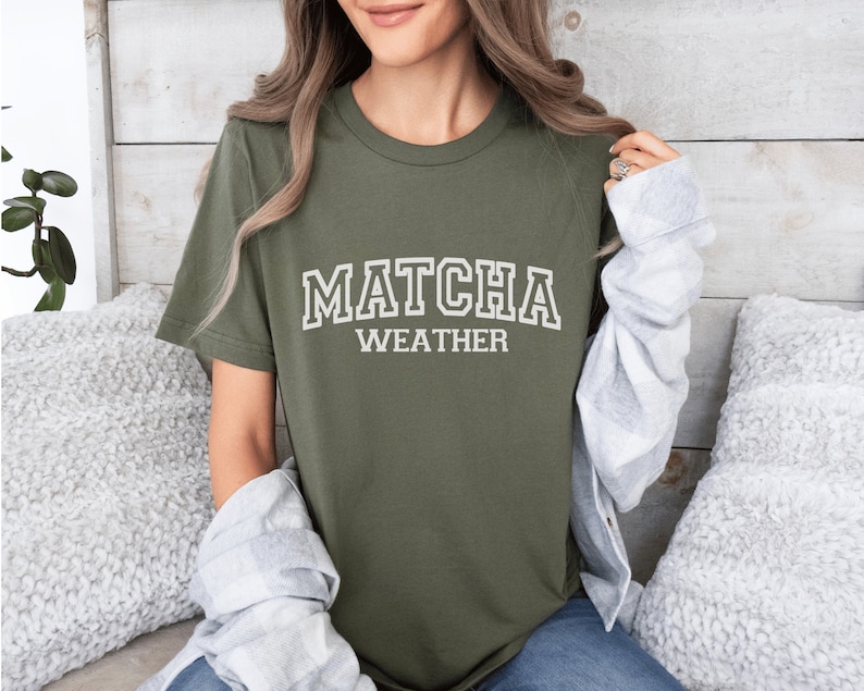 May include: A green t-shirt with the text "MATCHA WEATHER" in white block letters.