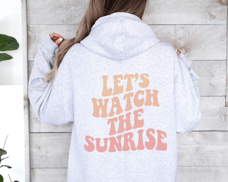 May include: A gray hoodie with a pink and orange graphic that says "Let's watch the sunrise".