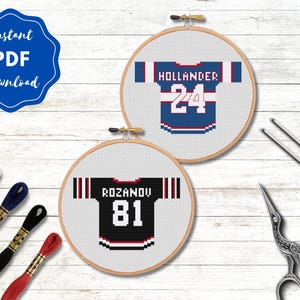 May include: Two cross-stitch hoops displaying hockey jerseys. One is blue with "HOLLANDER 24", the other is black with "ROZANOV 81". The image includes embroidery floss, needles, and scissors. A blue badge reads "Instant PDF Download".