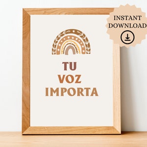 May include: A printable wall art print with a rainbow design and the text "TU VOZ IMPORTA" in brown lettering. The rainbow is made up of different shades of brown and has a floral design around it.