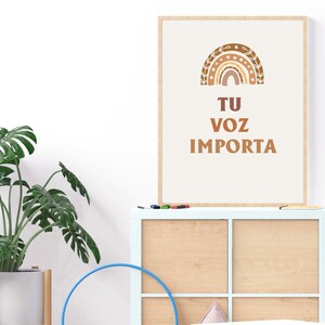 May include: A framed print with a brown and beige rainbow design and the text "TU VOZ IMPORTA" in brown lettering.