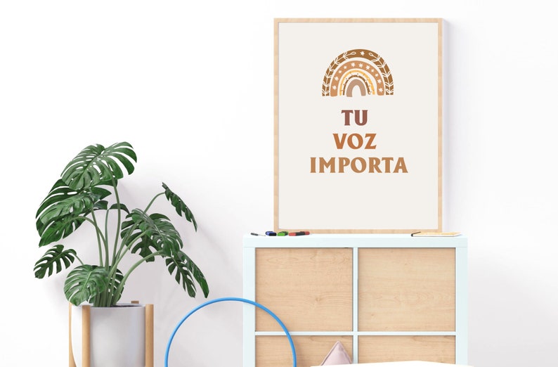 May include: A framed print with a brown and beige rainbow design and the text "TU VOZ IMPORTA" in brown lettering.