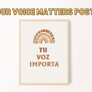 May include: A framed poster with a rainbow design and the text "TU VOZ IMPORTA" in brown lettering. The poster has a white background and a wooden frame.