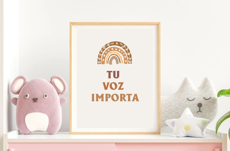 May include: A framed print with a brown and orange rainbow design and the text "TU VOZ IMPORTA" in brown lettering.