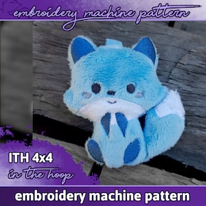 May include: Blue plush fox embroidery pattern for a 4x4 inch embroidery hoop. The pattern is for an in-the-hoop project, meaning the entire project is stitched within the hoop. The fox has a white belly and a white tail tip.