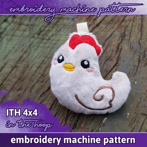May include: Embroidered plush chicken toy in the hoop, 4x4 inches, with a red comb, yellow beak, and brown eyes.  The toy is on a wooden surface.  ITH 4x4 in the hoop embroidery machine pattern.