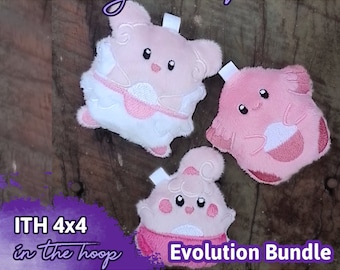 May include: Three pink and white plush toys in the shape of a Pokemon evolution line. The toys are on a wooden surface. The text "ITH 4x4 in the hoop" and "Evolution Bundle" is visible in the image.