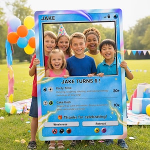 May include: A large, rectangular, blue-bordered photo frame designed to resemble a trading card. The card features the text JAKE, HP 6, JAKE TURNS 6!, Party Time, Cake Rush, and Thanks for celebrating!, along with various energy symbols.