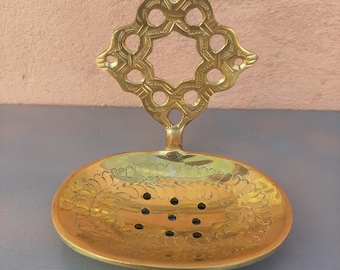 Unlacquered brass soap dish with drain, wall mounted.
