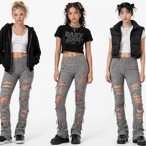 May include: Three outfits featuring grey distressed trousers with heavy rips and frayed edges. The looks include a black zip-up hoodie, a black cropped t-shirt with the text BABY 2000, and a black puffer vest, all paired with white tops and black shoes.