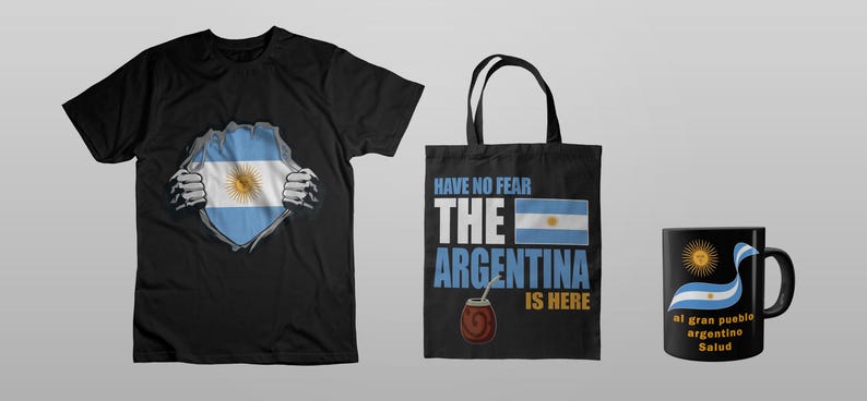 May include: A black t-shirt, tote bag, and mug featuring the Argentinian flag. The t-shirt design shows the flag bursting through a ripped shirt. The tote bag has the text "Have No Fear The Argentina Is Here". The mug has the flag and text.