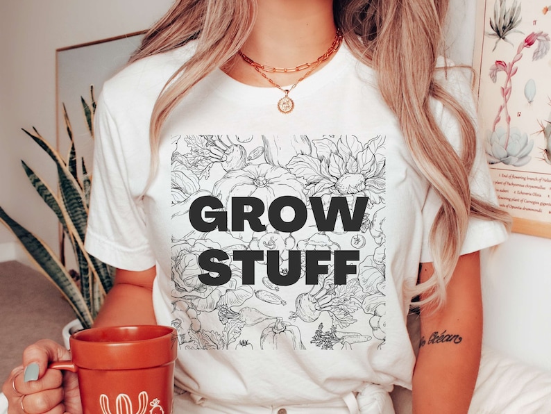 May include: White t-shirt with a black and white illustration of vegetables and the text "GROW STUFF" printed on the front.