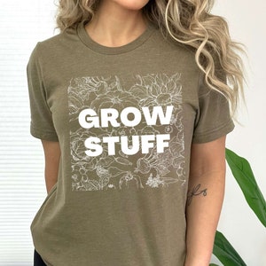 May include: A green t-shirt with a white graphic of flowers and the text "GROW STUFF".