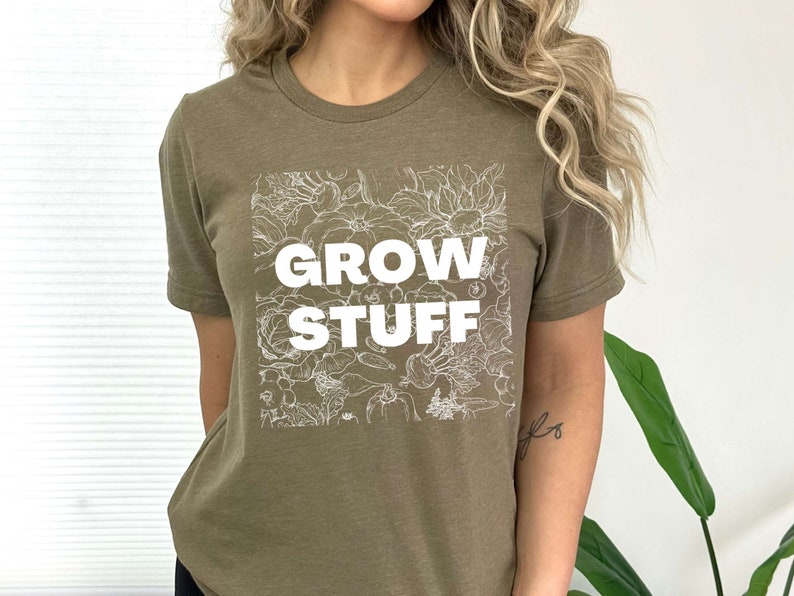 May include: A green t-shirt with a white graphic of flowers and the text "GROW STUFF".
